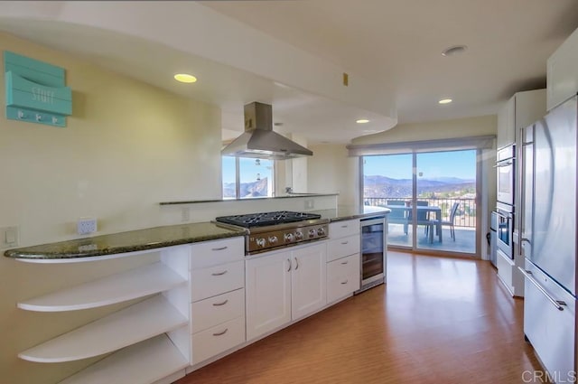 2638 W Victoria Dr, Alpine, CA 91901 - kitchen with island range hood, beverage cooler, stainless steel appliances, white cabinetry, and dark stone countertops