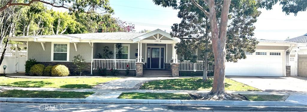1818 Samar Dr, Costa Mesa, CA 92626 - view of front of property with an attached garage, covered porch, stone siding, and concrete driveway