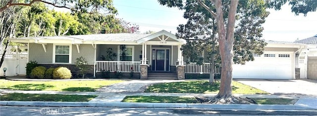 1818 Samar Dr, Costa Mesa, CA 92626 - view of front of property with an attached garage, covered porch, stone siding, and concrete driveway