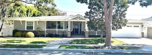 1818 Samar Dr, Costa Mesa, CA 92626 - view of front of property featuring a garage, a porch, stone siding, and concrete driveway