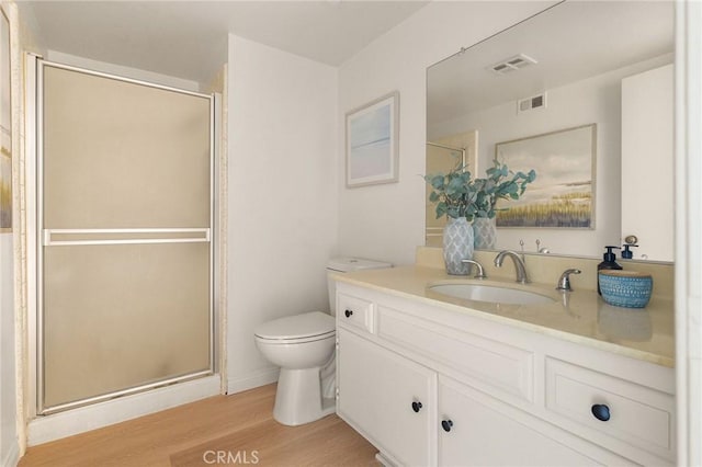 69 Cottonwood Cir, Rolling Hills Estates, CA 90274 - bathroom featuring toilet, wood finished floors, vanity, and a stall shower