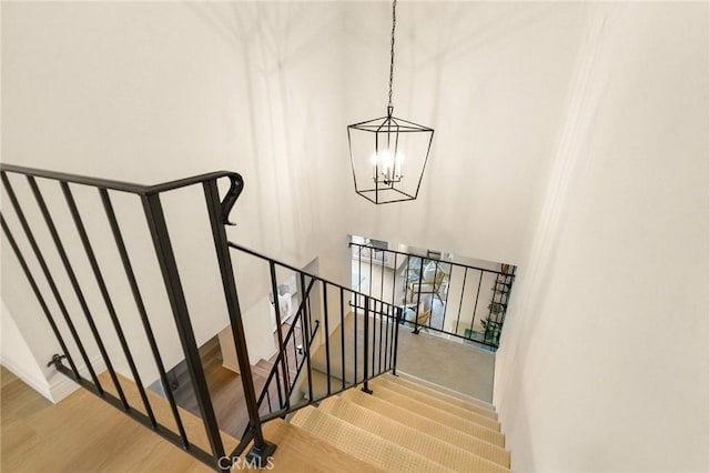 69 Cottonwood Cir, Rolling Hills Estates, CA 90274 - stairway featuring a chandelier and wood finished floors