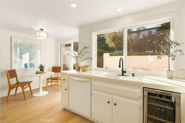 69 Cottonwood Cir, Rolling Hills Estates, CA 90274 - kitchen with dishwasher, beverage cooler, a sink, light countertops, and light wood-style floors