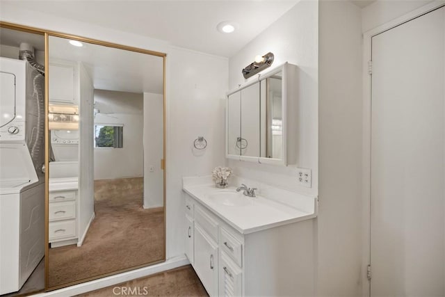 2319 Via Puerta Unit O, Laguna Woods, CA 92637 - bathroom featuring estacked washer and dryer, vanity, a ceiling fan, and recessed lighting
