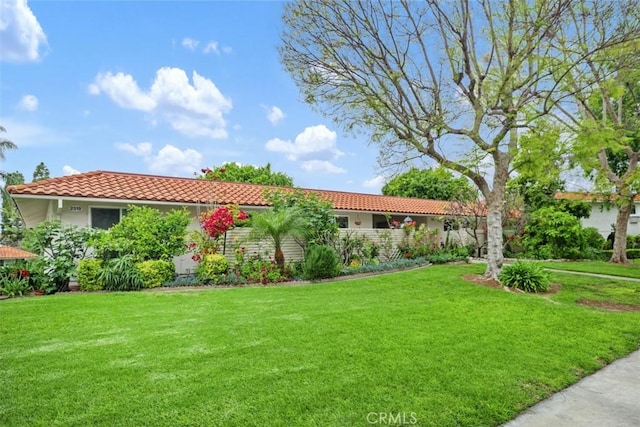 2319 Via Puerta Unit O, Laguna Woods, CA 92637 - view of front of house featuring a tile roof, a front lawn, and stucco siding