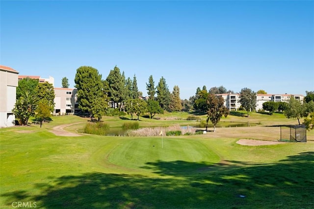 2319 Via Puerta Unit O, Laguna Woods, CA 92637 - surrounding community with golf course view, a water view, and a lawn
