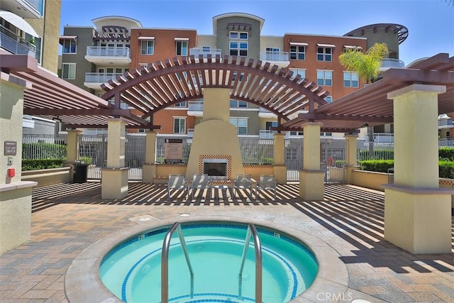 12668 Chapman Ave Unit 2403, Garden Grove, CA 92840 - view of pool featuring exterior fireplace, a pergola, fence, a patio, and a community hot tub