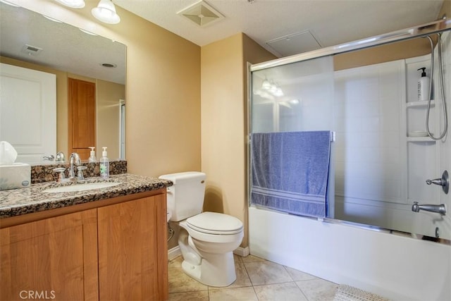 12668 Chapman Ave Unit 2403, Garden Grove, CA 92840 - bathroom with bath / shower combo with glass door, toilet, tile patterned flooring, and vanity