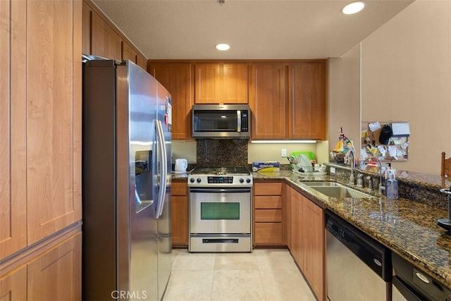 12668 Chapman Ave Unit 2403, Garden Grove, CA 92840 - kitchen with stainless steel appliances, a sink, dark stone countertops, light tile patterned flooring, and backsplash