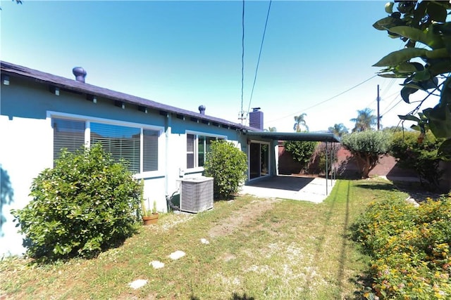 9943 Vernon Ave, Montclair, CA 91763 - back of house with central AC unit, a patio, stucco siding, and a chimney