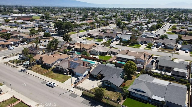 9943 Vernon Ave, Montclair, CA 91763 - aerial view of property and surrounding area featuring nearby suburban area and a mountainous background