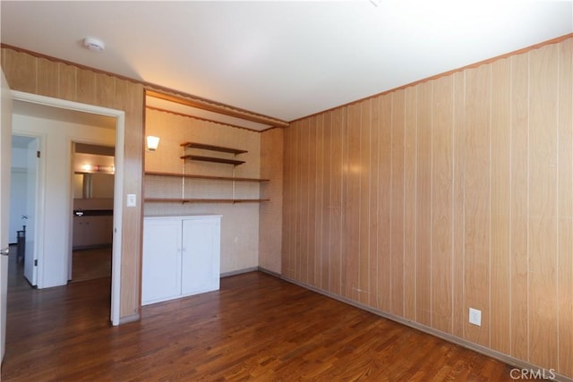 9943 Vernon Ave, Montclair, CA 91763 - unfurnished living room with dark wood finished floors and wood walls