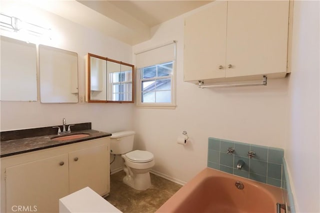 9943 Vernon Ave, Montclair, CA 91763 - bathroom featuring toilet, a bath, baseboards, and vanity