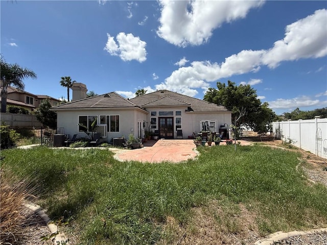 17287 Grove Dr, Riverside, CA 92503 - rear view of property featuring a patio area, french doors, stucco siding, and a chimney