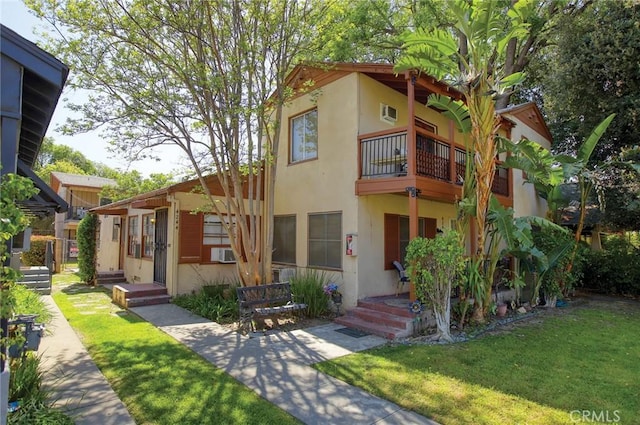 4250 10th St, Riverside, CA 92501 - view of front of home featuring a balcony, stucco siding, and a front lawn