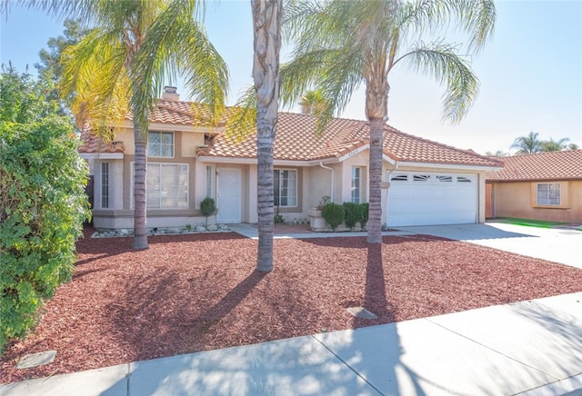43419 Olive Ave, Hemet, CA 92544 - mediterranean / spanish home with a tile roof, stucco siding, concrete driveway, and a garage