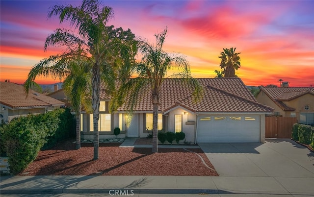 43419 Olive Ave, Hemet, CA 92544 - mediterranean / spanish-style house with a garage, stucco siding, driveway, and a tiled roof