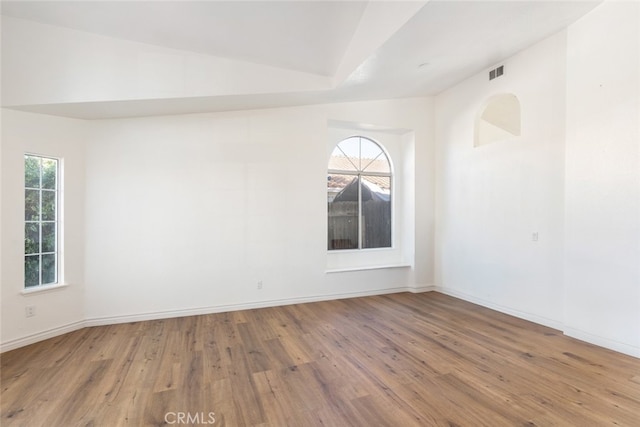43419 Olive Ave, Hemet, CA 92544 - empty room with wood finished floors, lofted ceiling, and baseboards