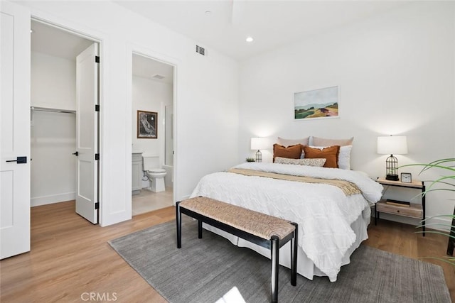 4140 Hillside Dr, San Luis Obispo, CA 93401 - bedroom with light wood-type flooring, recessed lighting, a walk in closet, baseboards, and connected bathroom
