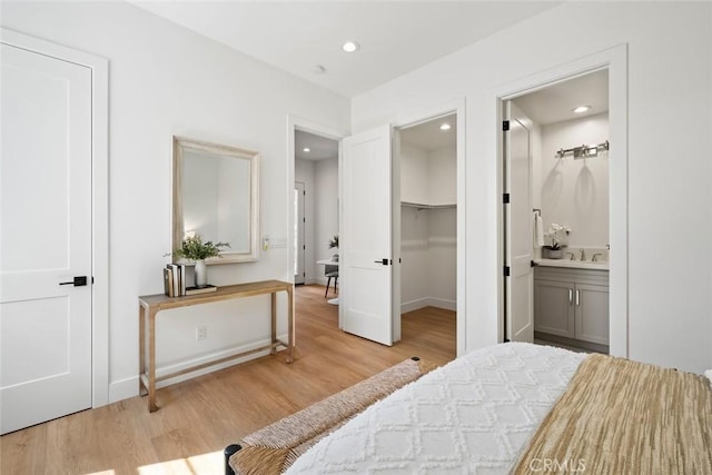 4140 Hillside Dr, San Luis Obispo, CA 93401 - bedroom featuring wood finished floors, ensuite bathroom, recessed lighting, a spacious closet, and a sink