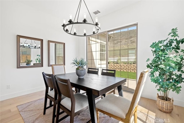 4140 Hillside Dr, San Luis Obispo, CA 93401 - dining room with a chandelier, light wood-style floors, and baseboards