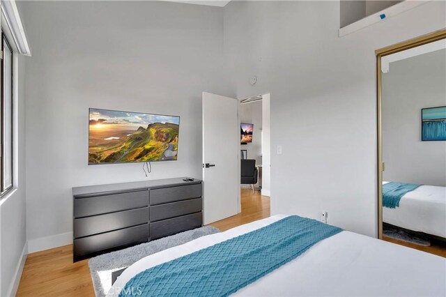 120 Avenida Santa Margarita, San Clemente, CA 92672 - bedroom featuring light wood finished floors, baseboards, and a towering ceiling
