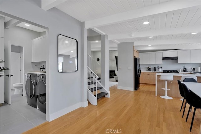 120 Avenida Santa Margarita, San Clemente, CA 92672 - kitchen with washing machine and clothes dryer, modern cabinets, extractor fan, a kitchen breakfast bar, and freestanding refrigerator