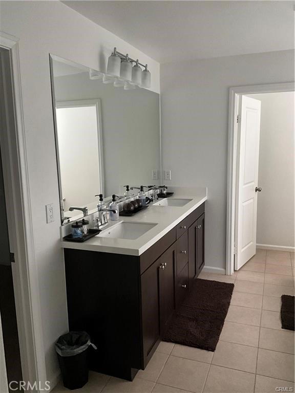 bathroom featuring tile patterned floors and double vanity