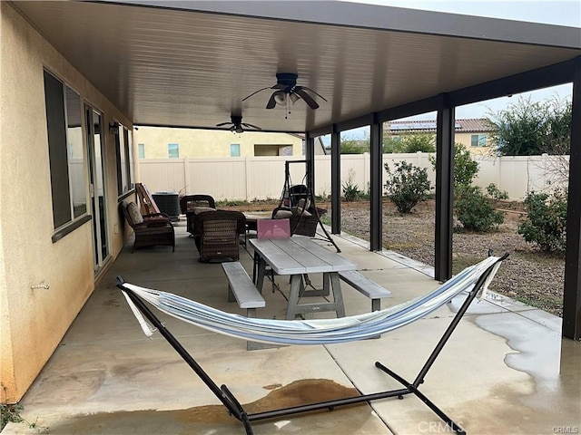 view of patio / terrace featuring a fenced backyard, a ceiling fan, an outdoor living space, and central AC unit