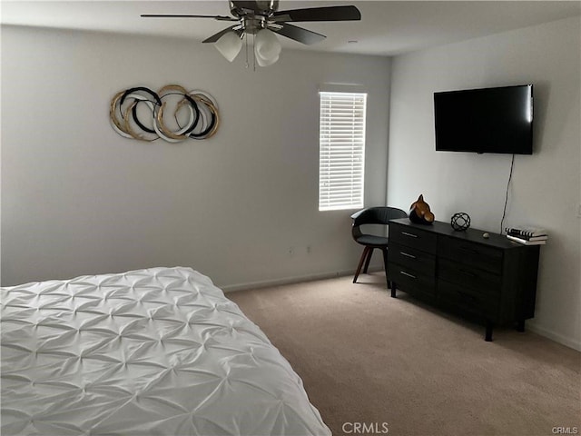 bedroom featuring light carpet, baseboards, and a ceiling fan