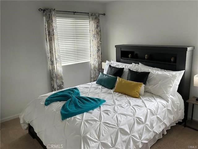 carpeted bedroom with baseboards