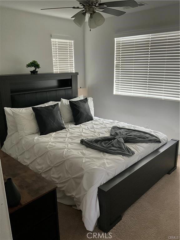bedroom with carpet flooring and a ceiling fan