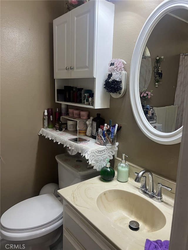 bathroom with vanity and toilet
