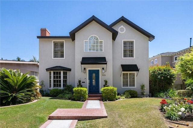 426 Ultimo Ave, Long Beach, CA 90814 - view of front of house with a chimney, stucco siding, and a front yard