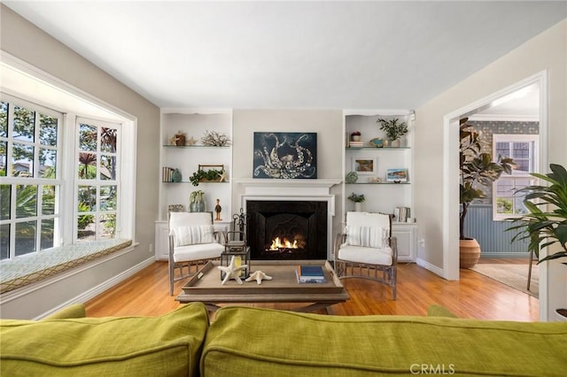 426 Ultimo Ave, Long Beach, CA 90814 - living room with a warm lit fireplace, wood finished floors, built in features, and baseboards