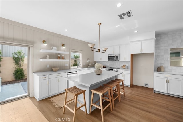 16225 Orizaba Ave, Paramount, CA 90723 - kitchen featuring appliances with stainless steel finishes, a sink, decorative backsplash, white cabinets, and recessed lighting