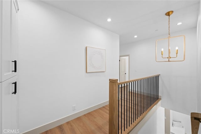16225 Orizaba Ave, Paramount, CA 90723 - hallway featuring wood finished floors, an upstairs landing, a chandelier, recessed lighting, and baseboards