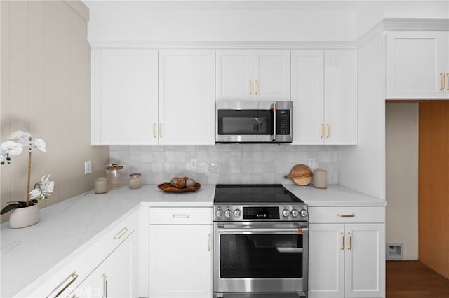 16225 Orizaba Ave, Paramount, CA 90723 - kitchen featuring appliances with stainless steel finishes, tasteful backsplash, white cabinets, and light stone counters