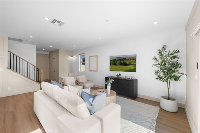 16225 Orizaba Ave, Paramount, CA 90723 - living room featuring stairway, light wood-style floors, recessed lighting, and baseboards