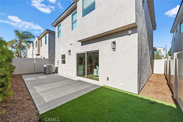 16225 Orizaba Ave, Paramount, CA 90723 - back of property featuring central AC unit, a patio area, and stucco siding