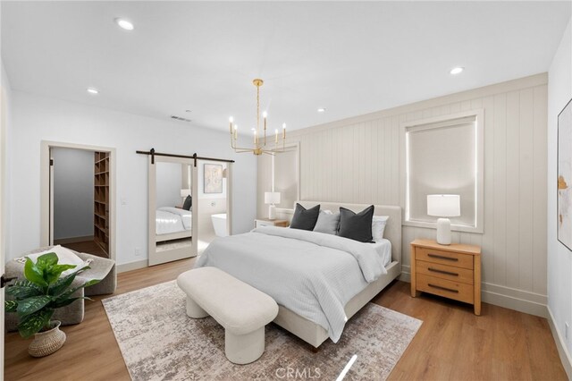 16225 Orizaba Ave, Paramount, CA 90723 - bedroom with a barn door, a chandelier, light wood-style floors, baseboards, and recessed lighting