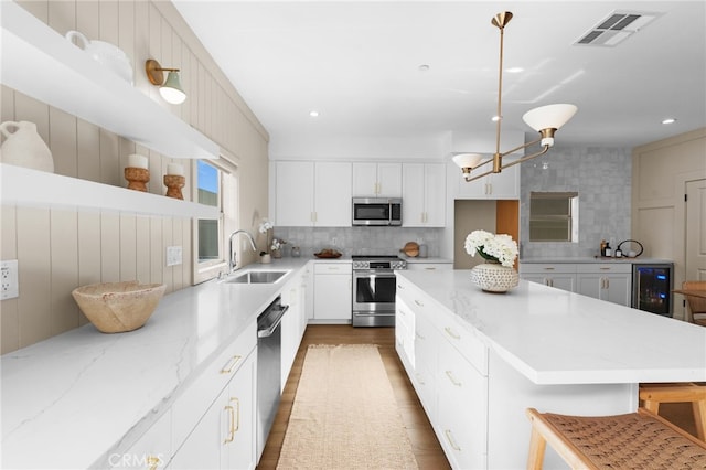 16225 Orizaba Ave, Paramount, CA 90723 - kitchen with stainless steel appliances, a sink, beverage cooler, decorative backsplash, and recessed lighting