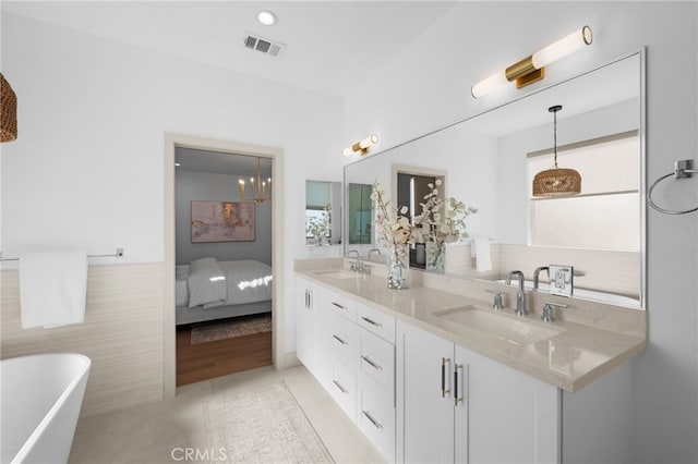 16225 Orizaba Ave, Paramount, CA 90723 - bathroom featuring double vanity, a freestanding tub, tile patterned floors, and connected bathroom