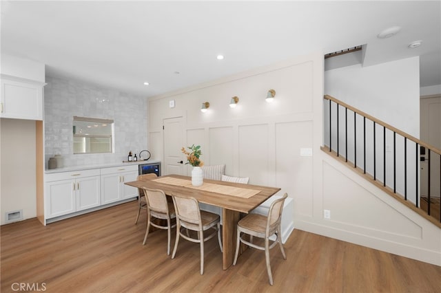 16225 Orizaba Ave, Paramount, CA 90723 - dining space with light wood-type flooring, stairs, recessed lighting, and a decorative wall