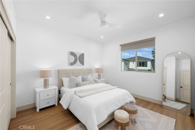 16225 Orizaba Ave, Paramount, CA 90723 - bedroom featuring arched walkways, light wood-style flooring, recessed lighting, a closet, and baseboards