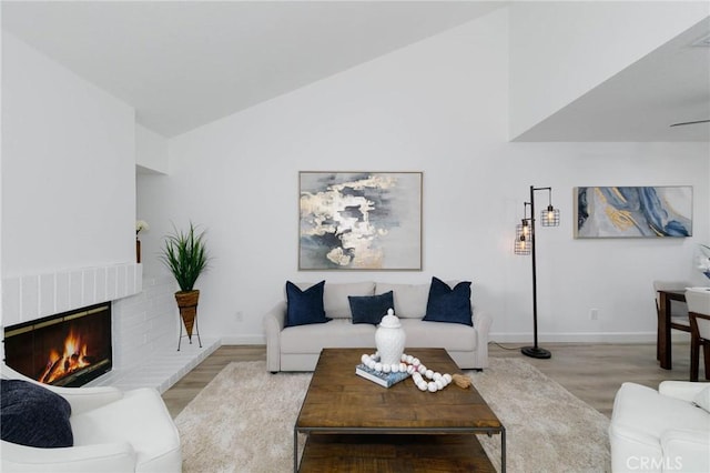 1327 Solera Ln Unit 6, Diamond Bar, CA 91765 - living room featuring wood finished floors, baseboards, vaulted ceiling, and a fireplace