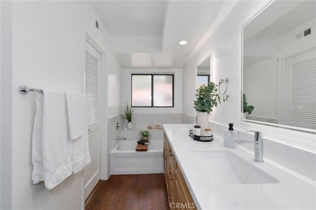 1327 Solera Ln Unit 6, Diamond Bar, CA 91765 - full bath featuring a bath, wood finished floors, double vanity, recessed lighting, and a tray ceiling
