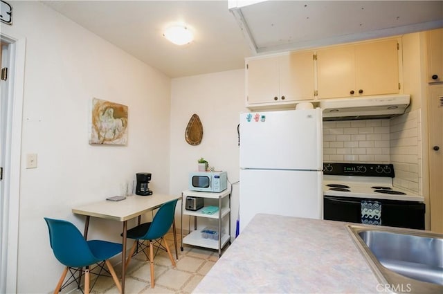 1905 Normal Ave, Chico, CA 95928 - kitchen with white appliances, under cabinet range hood, backsplash, light countertops, and light floors