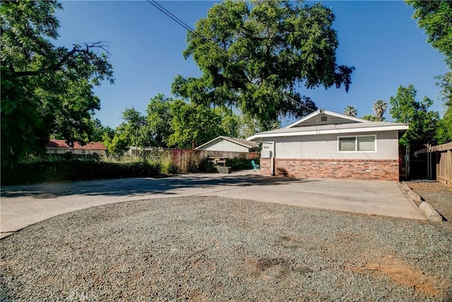 1905 Normal Ave, Chico, CA 95928 - view of home's exterior with brick siding, fence, and driveway