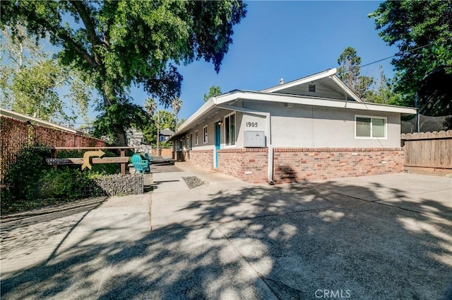 1905 Normal Ave, Chico, CA 95928 - view of side of home with brick siding, fence, and stucco siding